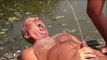 Dolly Diore has a golden shower with an old man by the lake